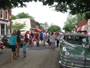 people downtown at car show