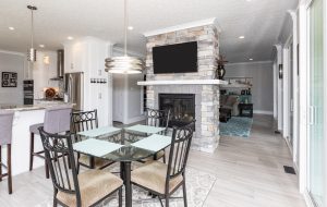 large kitchen and eating area with fireplace and tv